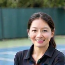 Portrait of Coach Sarah Chen, smiling confidently.